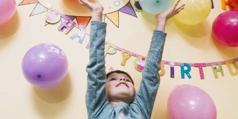 girl throwing up balloons (Medium)