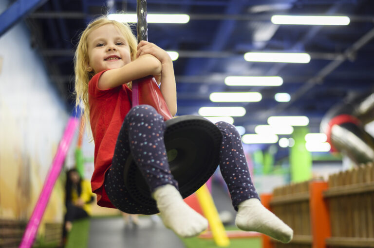 happy blonde girl playing indoors
